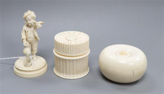 A Bavarian ivory figure of cupid as a boy and two ivory jars and covers
